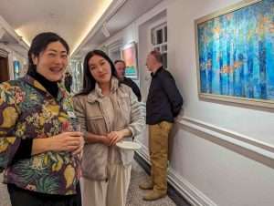 Artist Yang Xu (left) at the Private View, Elemental Exhibition, 6th March 2024